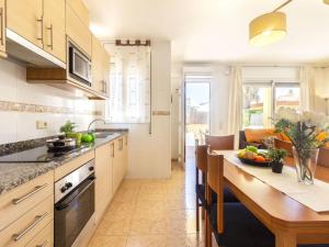 eine Küche mit Holztisch und ein Esszimmer in der Unterkunft Holiday Home Flamenc 3 by Interhome in Riumar