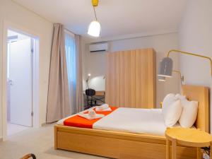 a bedroom with a bed and a table and a chair at Ultra Modern Apartment off St Julians in St Julian's