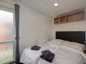 una camera da letto con un letto bianco con due sacchi sopra di Holiday Home Tiny Haus Central by Interhome a Beilngries