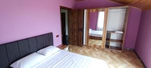a small bedroom with a bed and a mirror at Golden Heart in Batumi