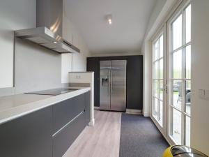 a kitchen with a refrigerator and a counter top at Holiday Home Ganuenta-1 by Interhome in Colijnsplaat