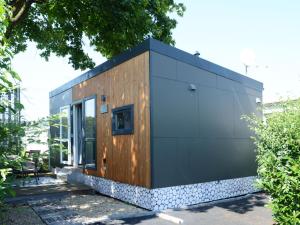 a small house with a black and wood exterior at Holiday Home Tiny Haus Engel by Interhome in Beilngries