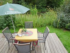 a table and chairs with an umbrella on a deck at Holiday Home Tiny Haus Sonnendeck by Interhome in Beilngries