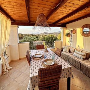 a patio with a table and a couch at Residenza Porto Istana in Murta Maria