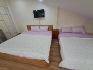 Postel nebo postele na pokoji v ubytování MrLee Dalat House