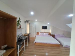 Postel nebo postele na pokoji v ubytování MrLee Dalat House