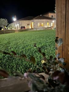 a field of grass at night with a fence at TENUTA ROSA - Gastronomia e Relax in Montesano Scalo