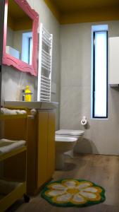 a bathroom with a sink and a toilet and a mirror at Pop House - Monza Park in Villasanta