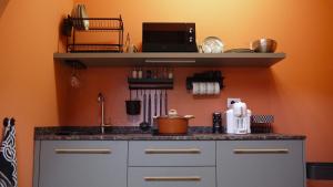 a kitchen with a sink and a counter top at Pop House - Monza Park in Villasanta +11 photos