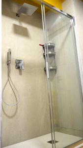 a shower with a glass door in a bathroom at Pop House - Monza Park in Villasanta
