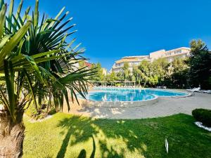 a swimming pool in the middle of a park at Charming 2-bed flat with pool view in Sunny Beach, Bulgaria in Sunny Beach +20 photos