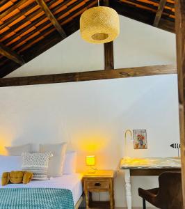 a bedroom with a bed and a table with a lamp at The Little Brezo Stone Home Tenerife in Los Realejos