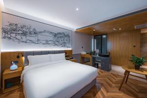 Postel nebo postele na pokoji v ubytování Qiu Guo Hotel Xidan Financial Street Beijing