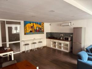 a living room with a blue couch and a kitchen at CityRest Fort in Colombo