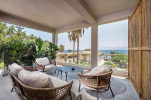 a living room with a view of the ocean at Sagredo Boutique Hotel & Spa in Ágios Fokás