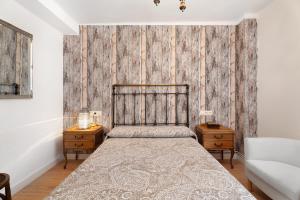 a bedroom with a bed and two night stands at Apartamento Rural Ordiso in Torla