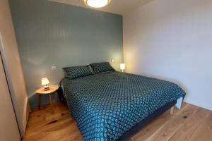 a bedroom with a bed and a side table at Gite 8 personnes Ussel Grande Maison rénovée in Ussel