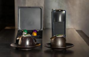 two tea pots on a table next to a tv at Hótel Kría in Vík