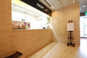 a counter in a store with a sign on the wall at Hotel New Star Ikebukuro in Tokyo