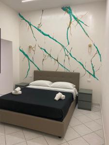 a bedroom with a bed with a painting on the wall at Maison Museo in Naples
