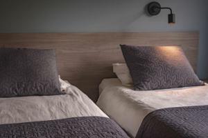 two beds sitting next to each other in a room at Hótel Kría in Vík