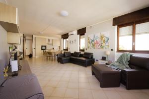 a large living room with couches and a table at Casa dei Pini in Tirano