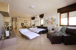 a living room with two beds and a couch at Casa dei Pini in Tirano +21 photos