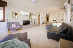 a living room with two couches and a tv at Casa dei Pini in Tirano