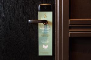 a doorhandle with a sign on it on a door at Strand Palace in London
