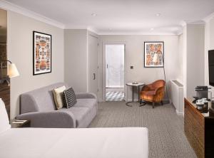 a living room with a couch and a table at Strand Palace in London