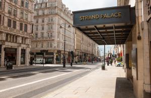 a street with a sign for aiant palace on a building at Strand Palace in London
