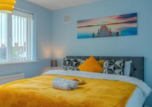 a bedroom with a yellow bed with a tray on it at Property Malak Homes - Coalville in Coalville
