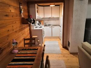 a small kitchen with a table and chairs in a room at SuLevi Apartment in Levi