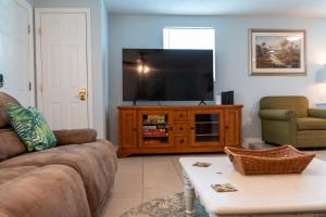 a living room with a couch and a flat screen tv at Waterfront Getaway in Hudson