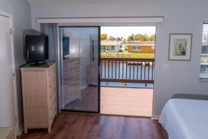 a bedroom with a sliding glass door to a balcony at Waterfront Getaway in Hudson