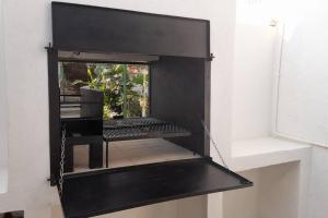 a black shelf in a room with a window at Peaceful Oasis near City Centre in Windhoek