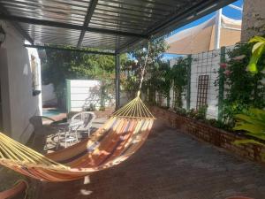 a hammock hanging from a porch with a patio at Peaceful Oasis near City Centre in Windhoek