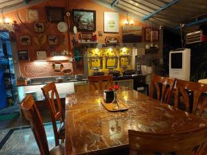 a dining room with a table and chairs in a restaurant at Wilderness Jungle Camp in Malavalli +29 photos