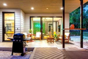 a patio with a grill and a table and chairs at Two-House Private 10BR Compound - DT 6 Min Drive in Austin +55 photos
