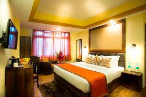 Cama o camas de una habitación en New Orchid Lords Inn Gangtok