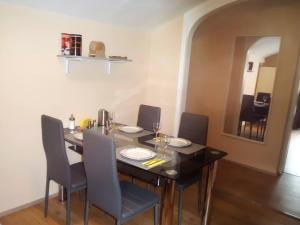 a dining room with a table and chairs and a mirror at Haus Marina Apartment Bergkristall mit Gratis Eintritt Alpentherme in Bad Hofgastein +12 photos