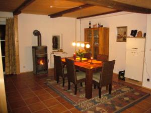 a dining room with a table and a wood stove at große Ferienwohnung Inselhuus in Nordstrand