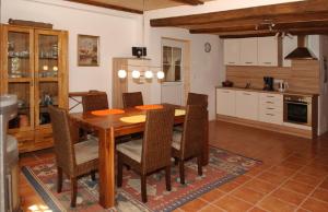 a kitchen and dining room with a wooden table and chairs at große Ferienwohnung Inselhuus in Nordstrand +12 photos