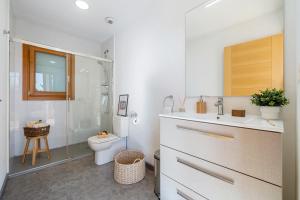 a bathroom with a toilet and a sink and a shower at Casa nórdica en el bosque con vistas al mar in Mont-ral +22 photos