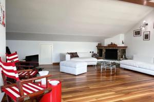 a living room with white furniture and a fireplace at House Bluette - Affitti Brevi Italia in Malgrate
