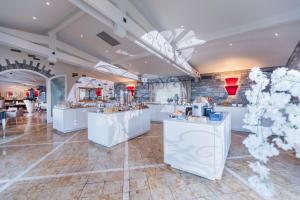 a salon with white counters and flowers in a room at Suite Appartement 713 in Ascona +79 photos