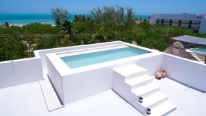 a swimming pool on the roof of a house at COCCOLOBA in Holbox Island