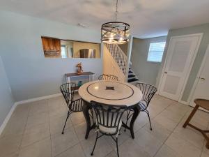a dining room with a table and chairs and a staircase at Paddle in the sunset with Manatee in Hudson +17 photos