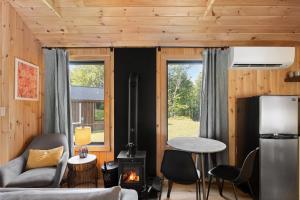 a living room with a couch and a stove at Vermont Scandinavian Chalet B in Wolcott