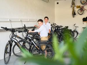a man and a boy sitting on a bike at Bloberger Hof in Salzburg